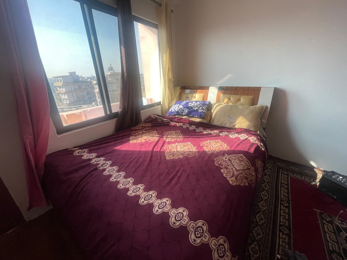 Jake's kitchen and bedroom with sunny balcony